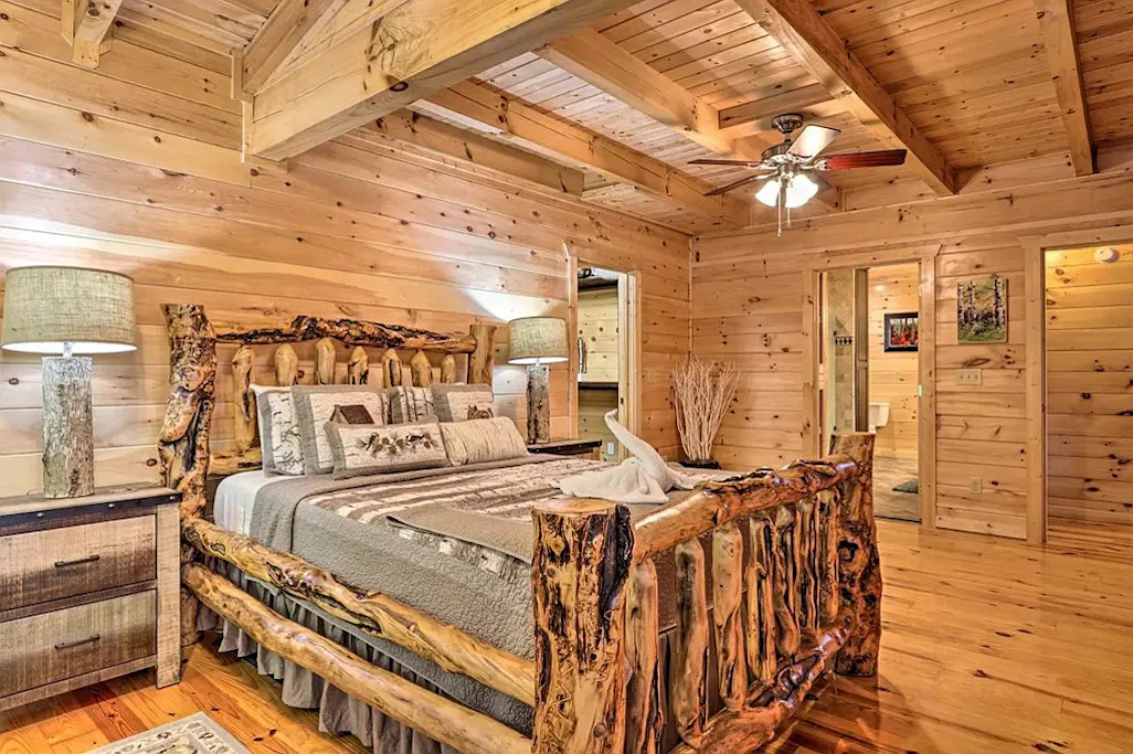 Main level Master bedroom with a large sitting area across the bed.