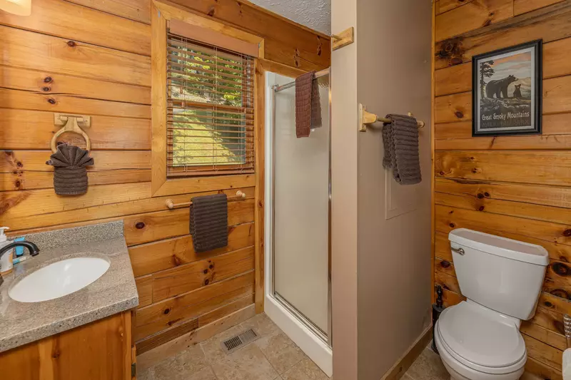 Updated bathroom with shower and tile floors on the left side.