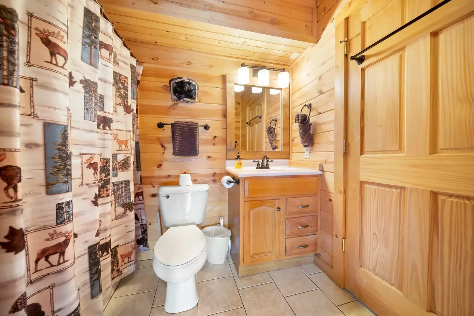 Downstairs updated bathroom with tub and doors to king bedroom and pool/game room.