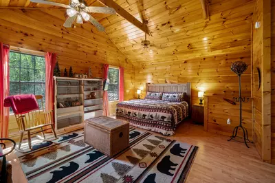Permanent Vacation, a cozy 1-bedroom cabin tucked in the woods of Sevierville. Guests love its quiet, private setting—perfect for honeymoons, anniversaries, or small family getaways. Just 8 miles from the Parkway in Pigeon Forge, you’ll enjoy the best of both worlds: peaceful seclusion and easy access to the Smoky Mountains’ best attractions.