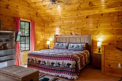 Permanent Vacation, a cozy 1-bedroom cabin tucked in the woods of Sevierville. Guests love its quiet, private setting—perfect for honeymoons, anniversaries, or small family getaways. Just 8 miles from the Parkway in Pigeon Forge, you’ll enjoy the best of both worlds: peaceful seclusion and easy access to the Smoky Mountains’ best attractions.
