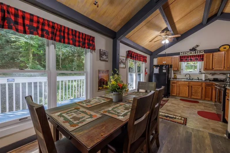 Misty Mountain Hop – a 2-bedroom, 2-bath Smoky Mountain cabin in Cobbly Nob Resort with screened-in hot tub, wrap-around decks, wood-burning fireplace, and access to pools, pickleball, and golf.