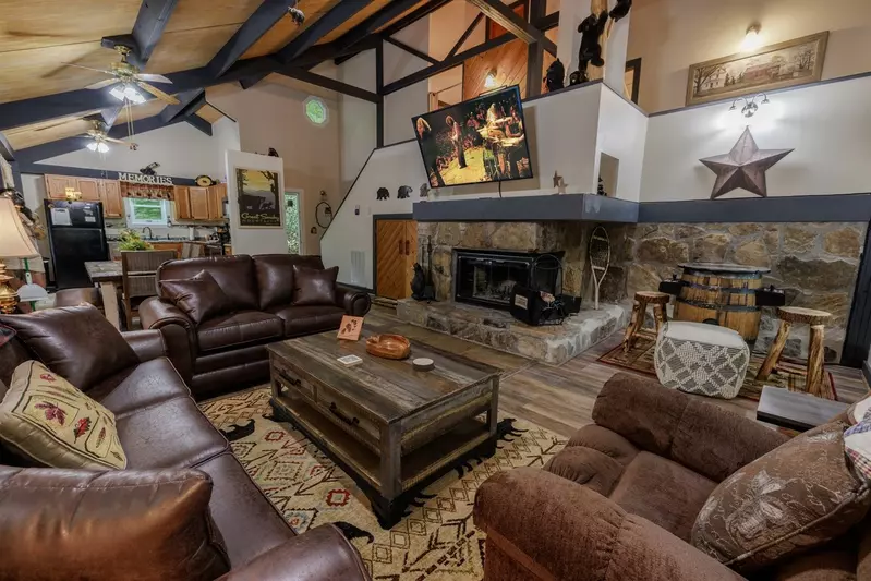 Misty Mountain Hop – a 2-bedroom, 2-bath Smoky Mountain cabin in Cobbly Nob Resort with screened-in hot tub, wrap-around decks, wood-burning fireplace, and access to pools, pickleball, and golf.