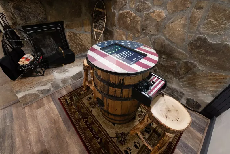 Misty Mountain Hop – a 2-bedroom, 2-bath Smoky Mountain cabin in Cobbly Nob Resort with screened-in hot tub, wrap-around decks, wood-burning fireplace, and access to pools, pickleball, and golf.