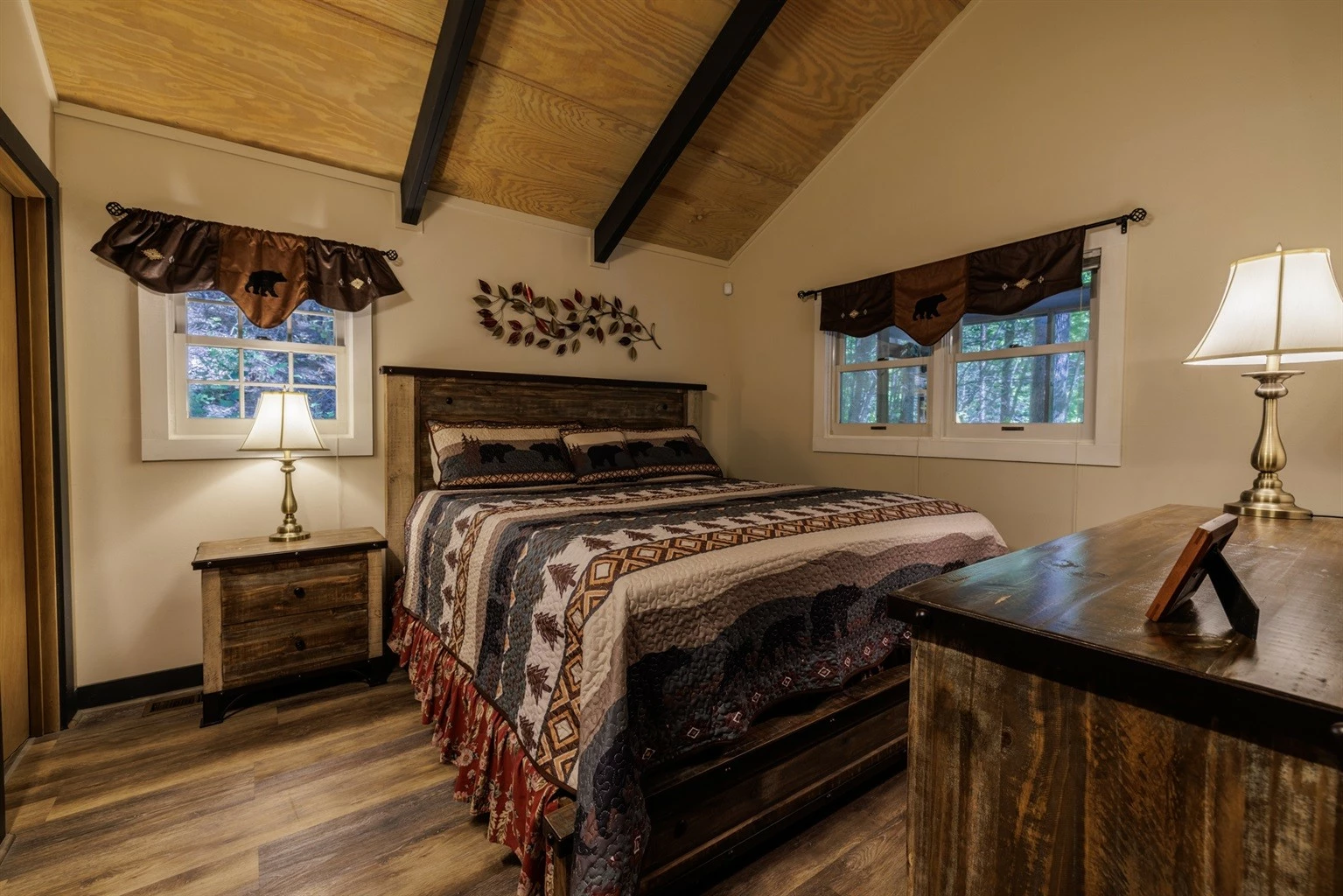 Misty Mountain Hop – a 2-bedroom, 2-bath Smoky Mountain cabin in Cobbly Nob Resort with screened-in hot tub, wrap-around decks, wood-burning fireplace, and access to pools, pickleball, and golf.