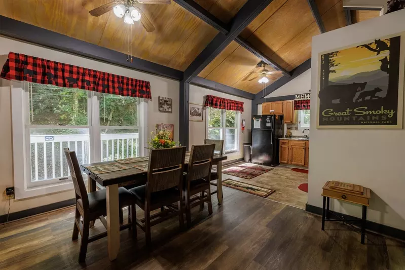 Misty Mountain Hop – a 2-bedroom, 2-bath Smoky Mountain cabin in Cobbly Nob Resort with screened-in hot tub, wrap-around decks, wood-burning fireplace, and access to pools, pickleball, and golf.