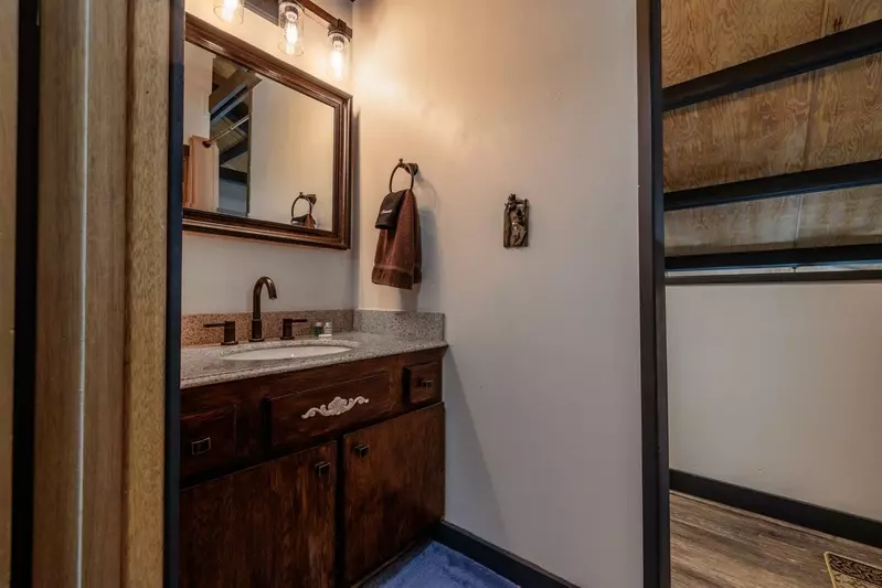 Misty Mountain Hop – a 2-bedroom, 2-bath Smoky Mountain cabin in Cobbly Nob Resort with screened-in hot tub, wrap-around decks, wood-burning fireplace, and access to pools, pickleball, and golf.