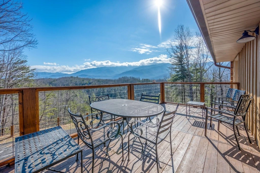 Happy Trails, a spacious 3BR/3BA mountain cabin in Gatlinburg’s coveted Cobbly Nob Resort. Perched on Webb Mountain, this beautifully decorated retreat offers over 2,100 sq. ft. of comfort with panoramic views of three mountain ranges, two wood-burning fireplaces, and plenty of amenities for families and groups to relax and reconnect.