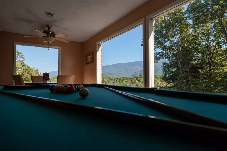Happy Trails, a spacious 3BR/3BA mountain cabin in Gatlinburg’s coveted Cobbly Nob Resort. Perched on Webb Mountain, this beautifully decorated retreat offers over 2,100 sq. ft. of comfort with panoramic views of three mountain ranges, two wood-burning fireplaces, and plenty of amenities for families and groups to relax and reconnect.