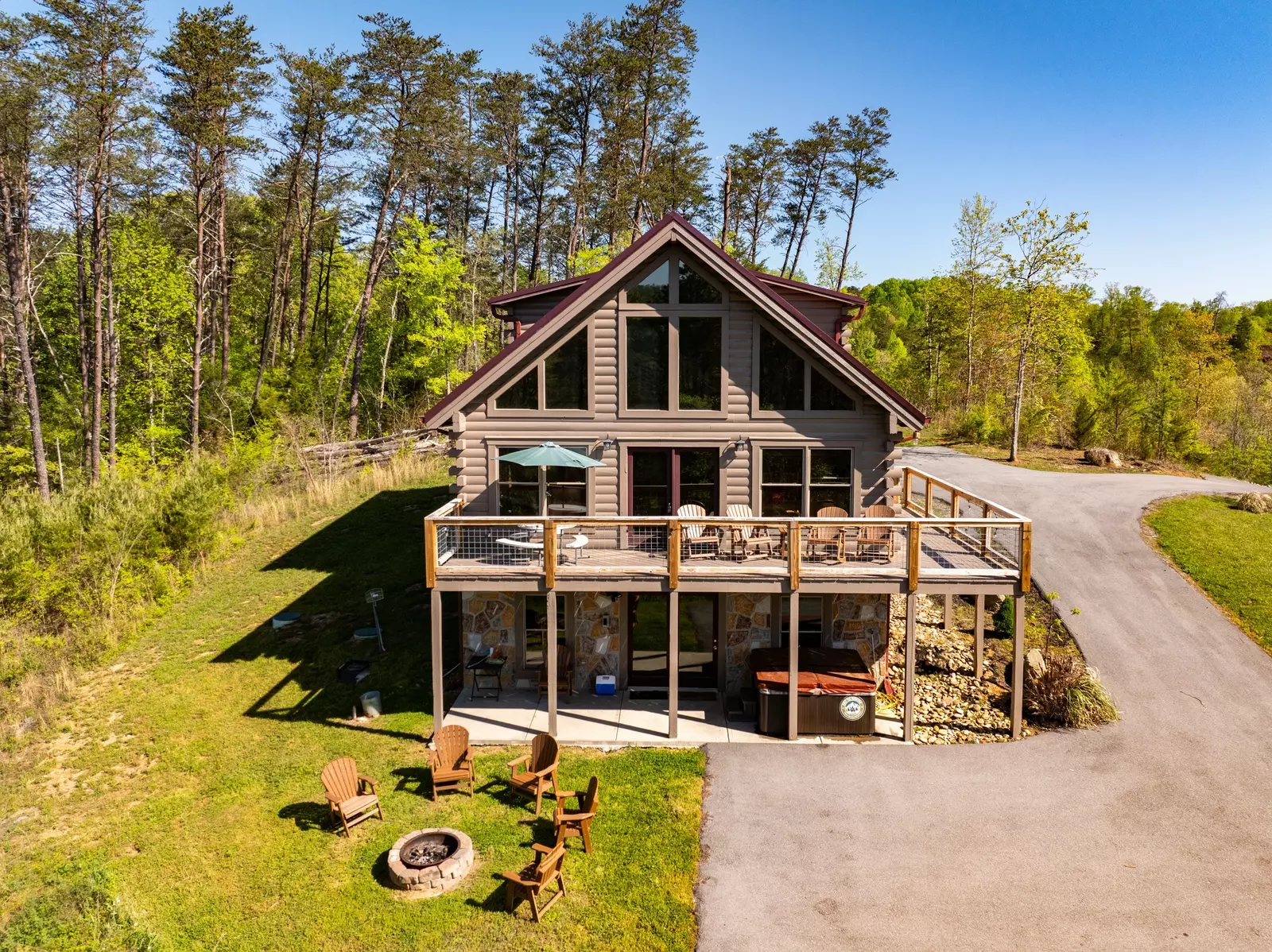 Nothin’ But a Good Time – a spacious 4-bedroom Smoky Mountain cabin rental in Sevierville featuring king bedrooms, twin bunks, hot tub, theater room, fire pit, and cozy mountain views.