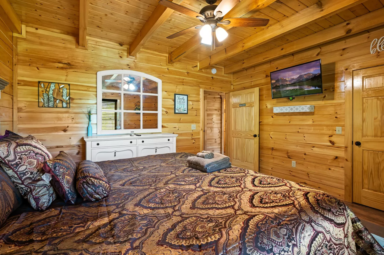 Nothin’ But a Good Time – a spacious 4-bedroom Smoky Mountain cabin rental in Sevierville featuring king bedrooms, twin bunks, hot tub, theater room, fire pit, and cozy mountain views.