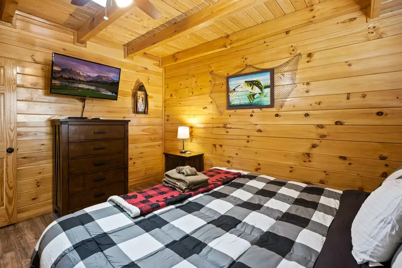 Nothin’ But a Good Time – a spacious 4-bedroom Smoky Mountain cabin rental in Sevierville featuring king bedrooms, twin bunks, hot tub, theater room, fire pit, and cozy mountain views.