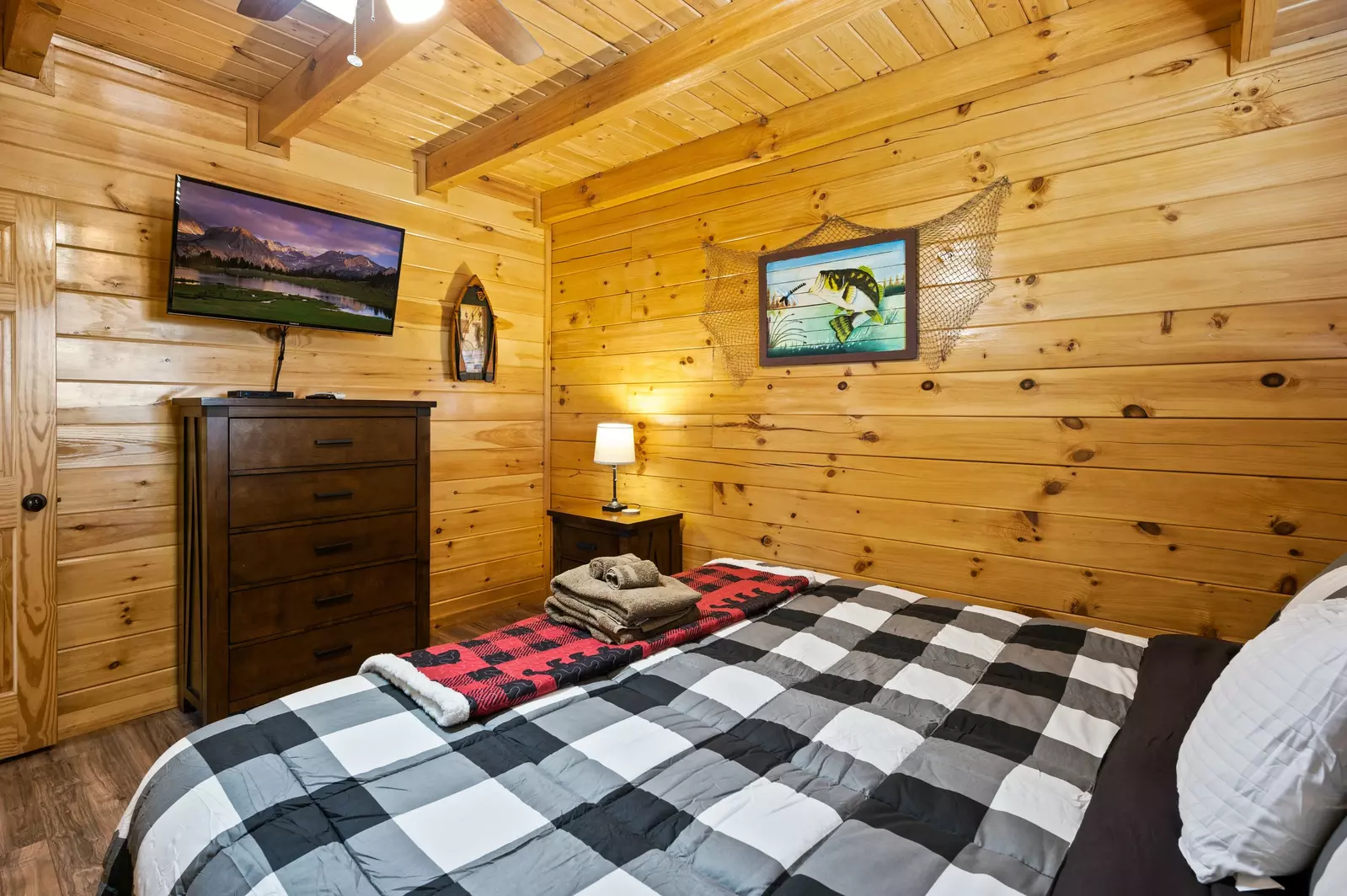 Nothin’ But a Good Time – a spacious 4-bedroom Smoky Mountain cabin rental in Sevierville featuring king bedrooms, twin bunks, hot tub, theater room, fire pit, and cozy mountain views.