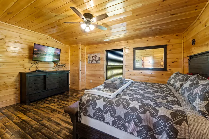 Nothin’ But a Good Time – a spacious 4-bedroom Smoky Mountain cabin rental in Sevierville featuring king bedrooms, twin bunks, hot tub, theater room, fire pit, and cozy mountain views.