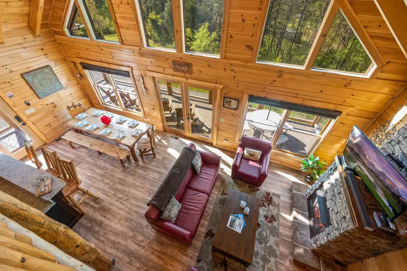 Nothin’ But a Good Time – a spacious 4-bedroom Smoky Mountain cabin rental in Sevierville featuring king bedrooms, twin bunks, hot tub, theater room, fire pit, and cozy mountain views.