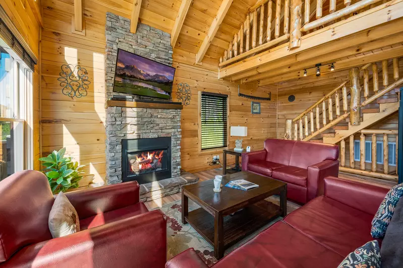 Nothin’ But a Good Time – a spacious 4-bedroom Smoky Mountain cabin rental in Sevierville featuring king bedrooms, twin bunks, hot tub, theater room, fire pit, and cozy mountain views.