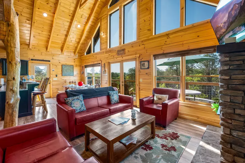 Nothin’ But a Good Time – a spacious 4-bedroom Smoky Mountain cabin rental in Sevierville featuring king bedrooms, twin bunks, hot tub, theater room, fire pit, and cozy mountain views.