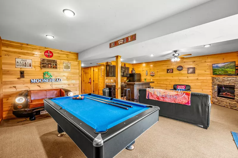 Nothin’ But a Good Time – a spacious 4-bedroom Smoky Mountain cabin rental in Sevierville featuring king bedrooms, twin bunks, hot tub, theater room, fire pit, and cozy mountain views.