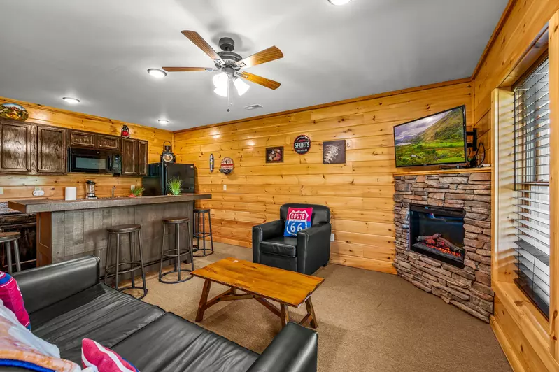 Nothin’ But a Good Time – a spacious 4-bedroom Smoky Mountain cabin rental in Sevierville featuring king bedrooms, twin bunks, hot tub, theater room, fire pit, and cozy mountain views.