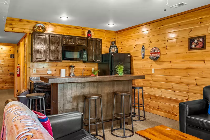 Nothin’ But a Good Time – a spacious 4-bedroom Smoky Mountain cabin rental in Sevierville featuring king bedrooms, twin bunks, hot tub, theater room, fire pit, and cozy mountain views.