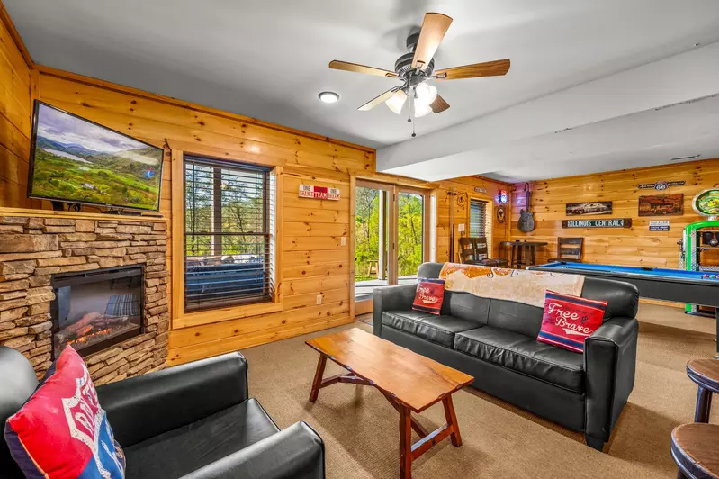 Nothin’ But a Good Time – a spacious 4-bedroom Smoky Mountain cabin rental in Sevierville featuring king bedrooms, twin bunks, hot tub, theater room, fire pit, and cozy mountain views.