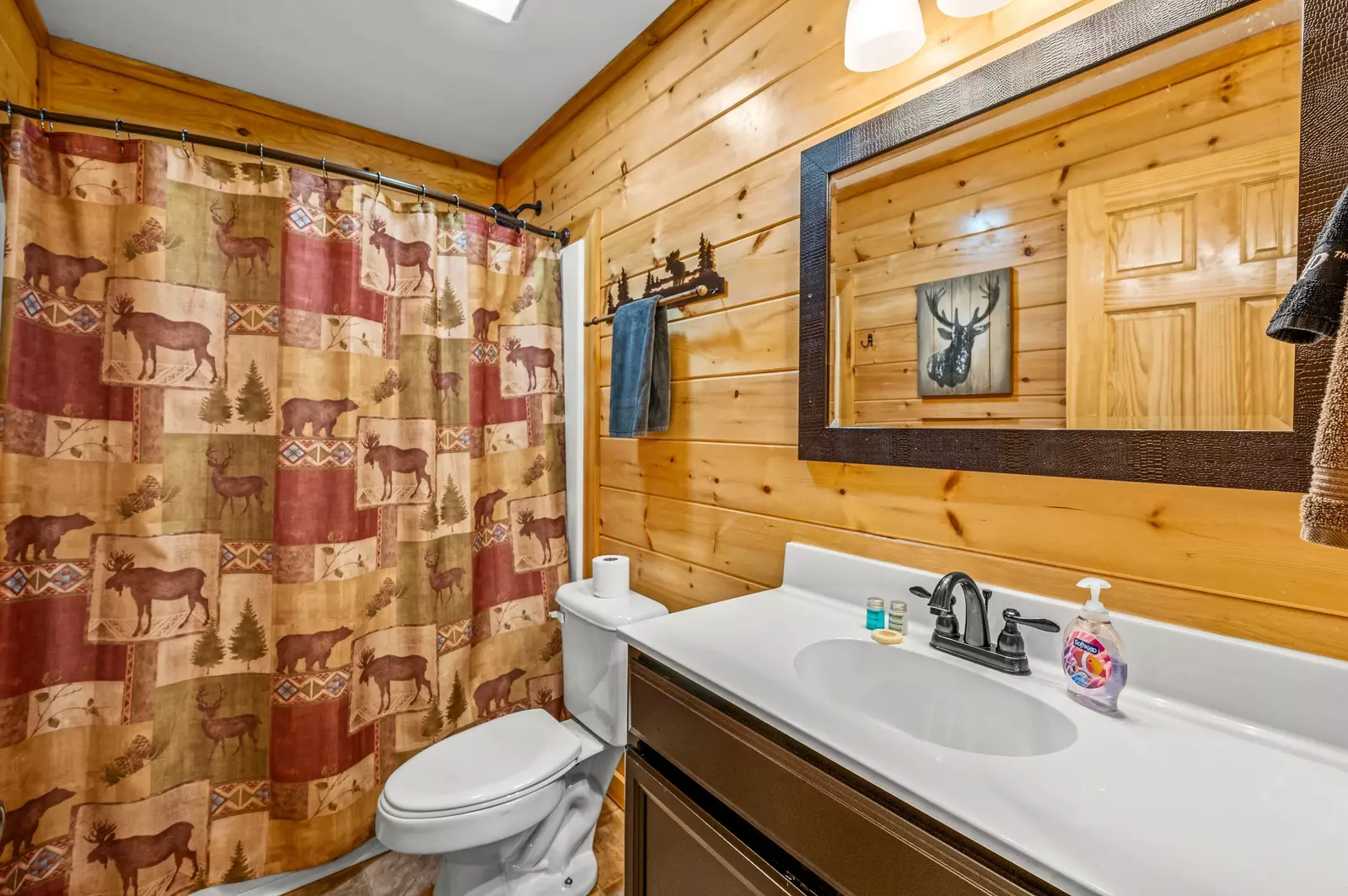 Nothin’ But a Good Time – a spacious 4-bedroom Smoky Mountain cabin rental in Sevierville featuring king bedrooms, twin bunks, hot tub, theater room, fire pit, and cozy mountain views.