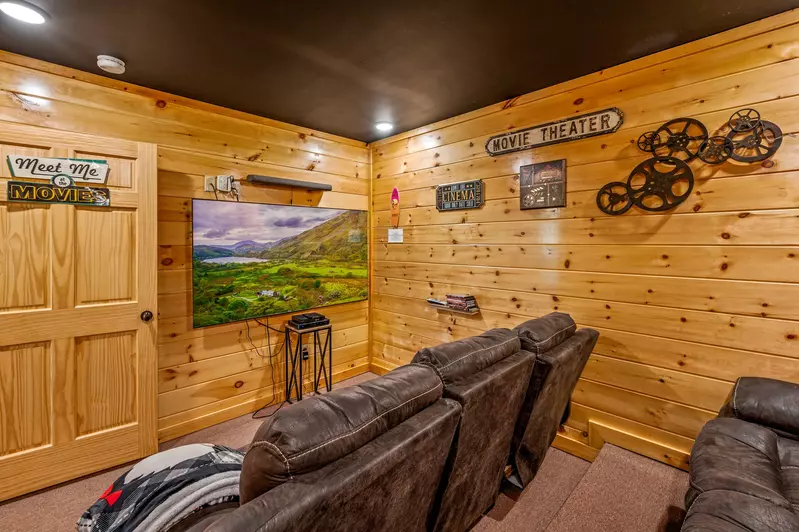 Nothin’ But a Good Time – a spacious 4-bedroom Smoky Mountain cabin rental in Sevierville featuring king bedrooms, twin bunks, hot tub, theater room, fire pit, and cozy mountain views.