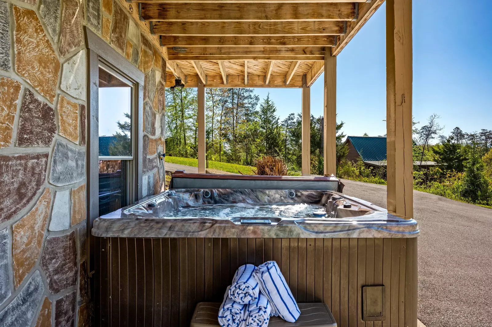 Nothin’ But a Good Time – a spacious 4-bedroom Smoky Mountain cabin rental in Sevierville featuring king bedrooms, twin bunks, hot tub, theater room, fire pit, and cozy mountain views.