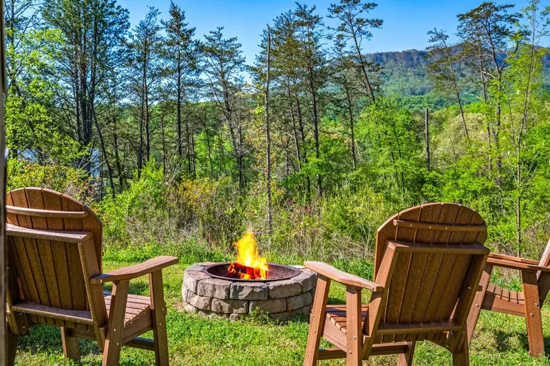 Nothin’ But a Good Time – a spacious 4-bedroom Smoky Mountain cabin rental in Sevierville featuring king bedrooms, twin bunks, hot tub, theater room, fire pit, and cozy mountain views.