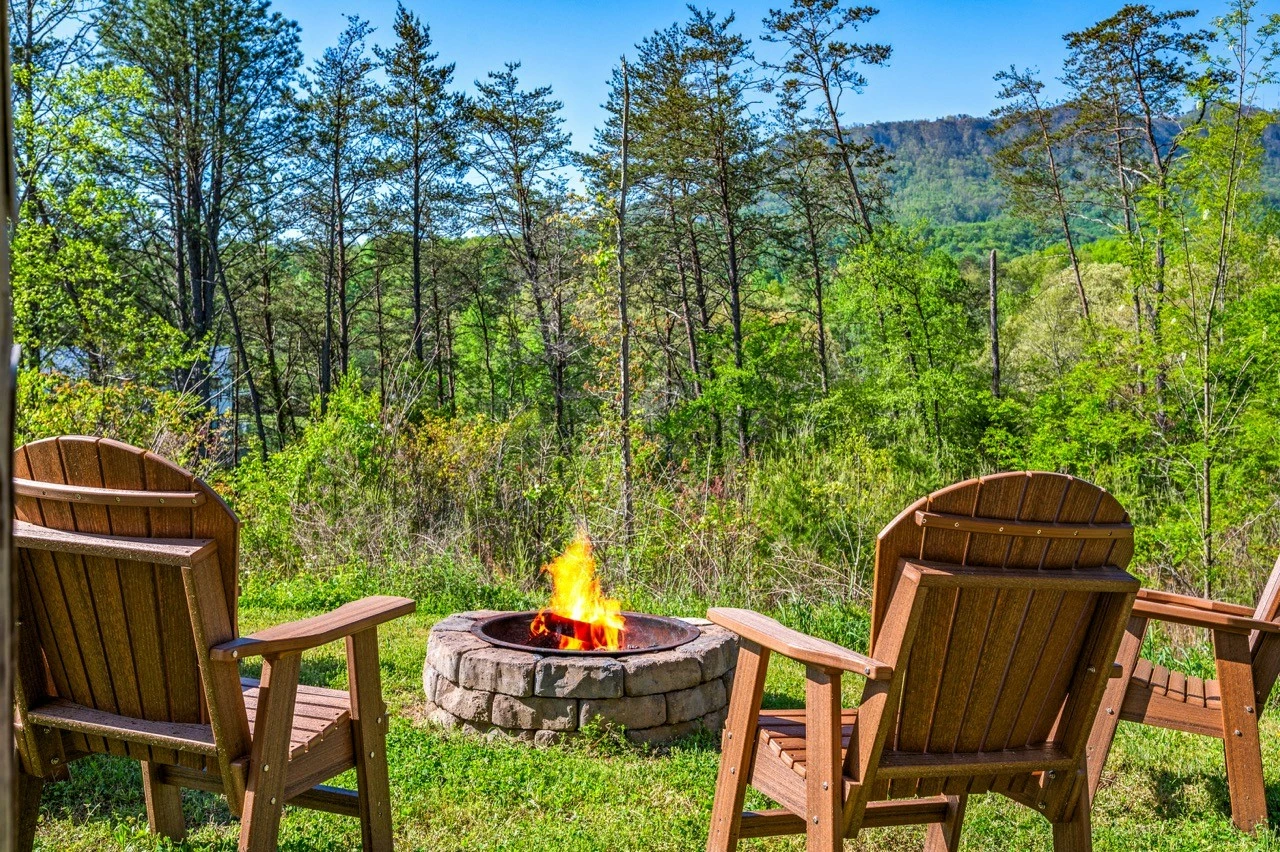 Nothin’ But a Good Time – a spacious 4-bedroom Smoky Mountain cabin rental in Sevierville featuring king bedrooms, twin bunks, hot tub, theater room, fire pit, and cozy mountain views.