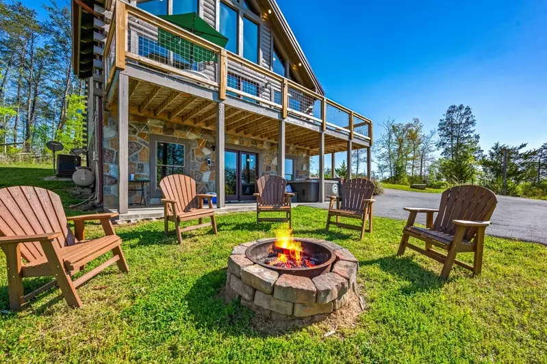 Nothin’ But a Good Time – a spacious 4-bedroom Smoky Mountain cabin rental in Sevierville featuring king bedrooms, twin bunks, hot tub, theater room, fire pit, and cozy mountain views.