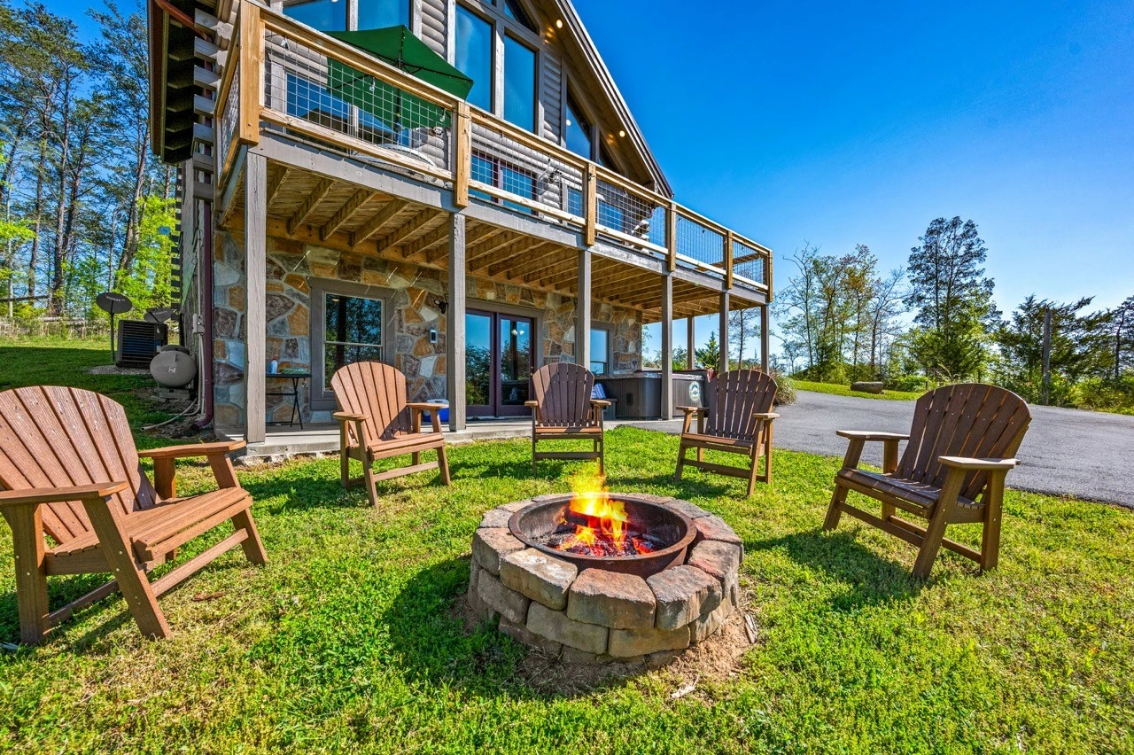 Nothin’ But a Good Time – a spacious 4-bedroom Smoky Mountain cabin rental in Sevierville featuring king bedrooms, twin bunks, hot tub, theater room, fire pit, and cozy mountain views.