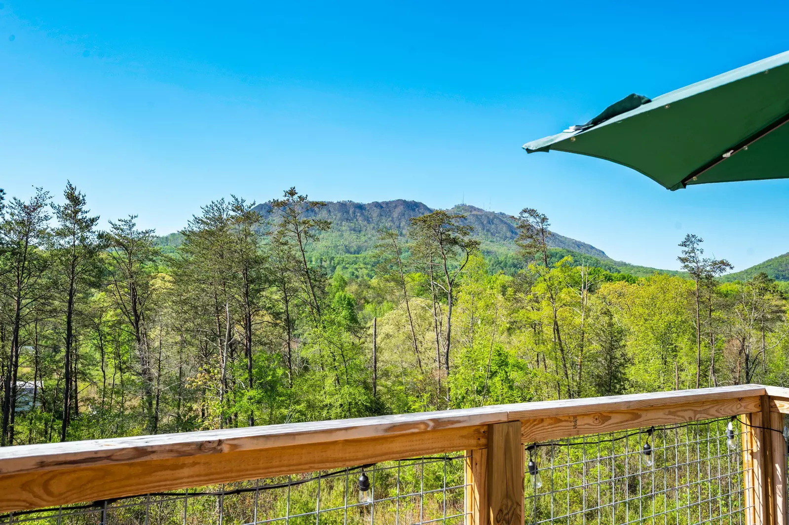 Nothin’ But a Good Time – a spacious 4-bedroom Smoky Mountain cabin rental in Sevierville featuring king bedrooms, twin bunks, hot tub, theater room, fire pit, and cozy mountain views.