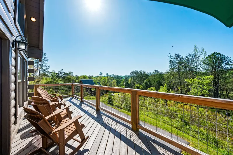 Nothin’ But a Good Time – a spacious 4-bedroom Smoky Mountain cabin rental in Sevierville featuring king bedrooms, twin bunks, hot tub, theater room, fire pit, and cozy mountain views.