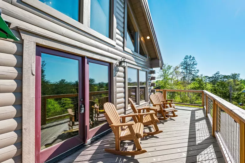 Nothin’ But a Good Time – a spacious 4-bedroom Smoky Mountain cabin rental in Sevierville featuring king bedrooms, twin bunks, hot tub, theater room, fire pit, and cozy mountain views.