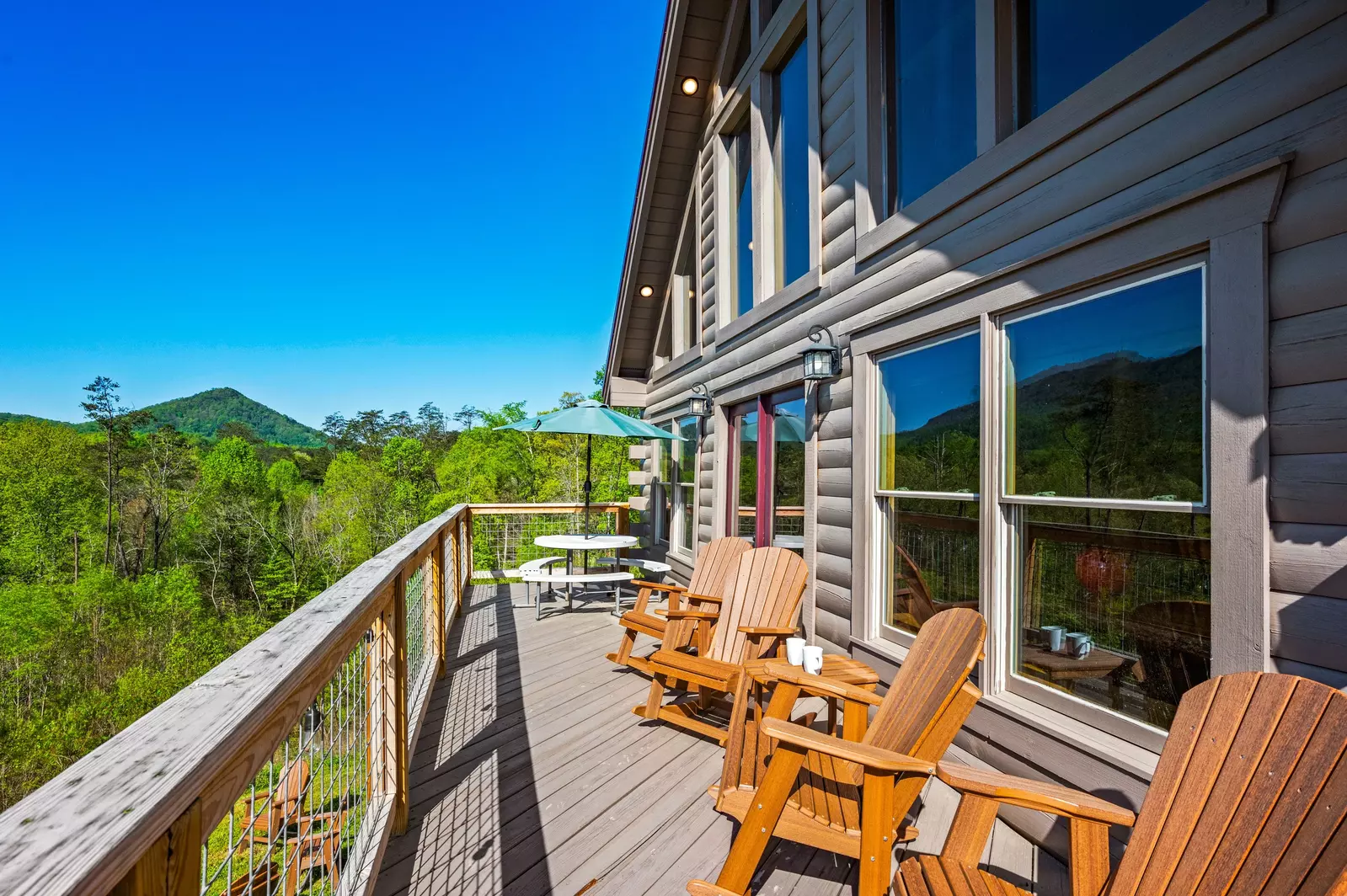 Nothin’ But a Good Time – a spacious 4-bedroom Smoky Mountain cabin rental in Sevierville featuring king bedrooms, twin bunks, hot tub, theater room, fire pit, and cozy mountain views.
