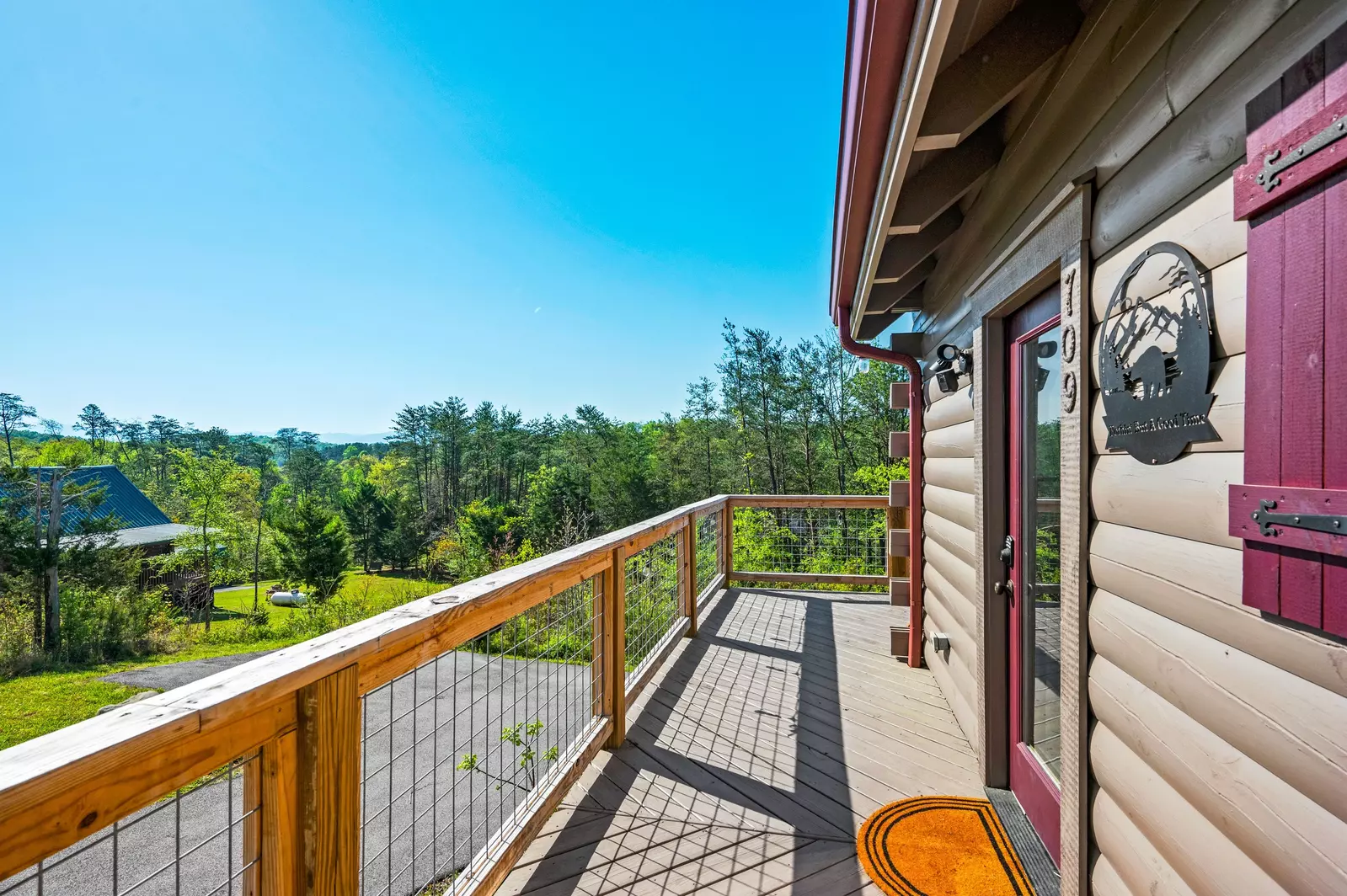 Nothin’ But a Good Time – a spacious 4-bedroom Smoky Mountain cabin rental in Sevierville featuring king bedrooms, twin bunks, hot tub, theater room, fire pit, and cozy mountain views.