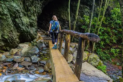 hiker crossing bridge in smoky mountains