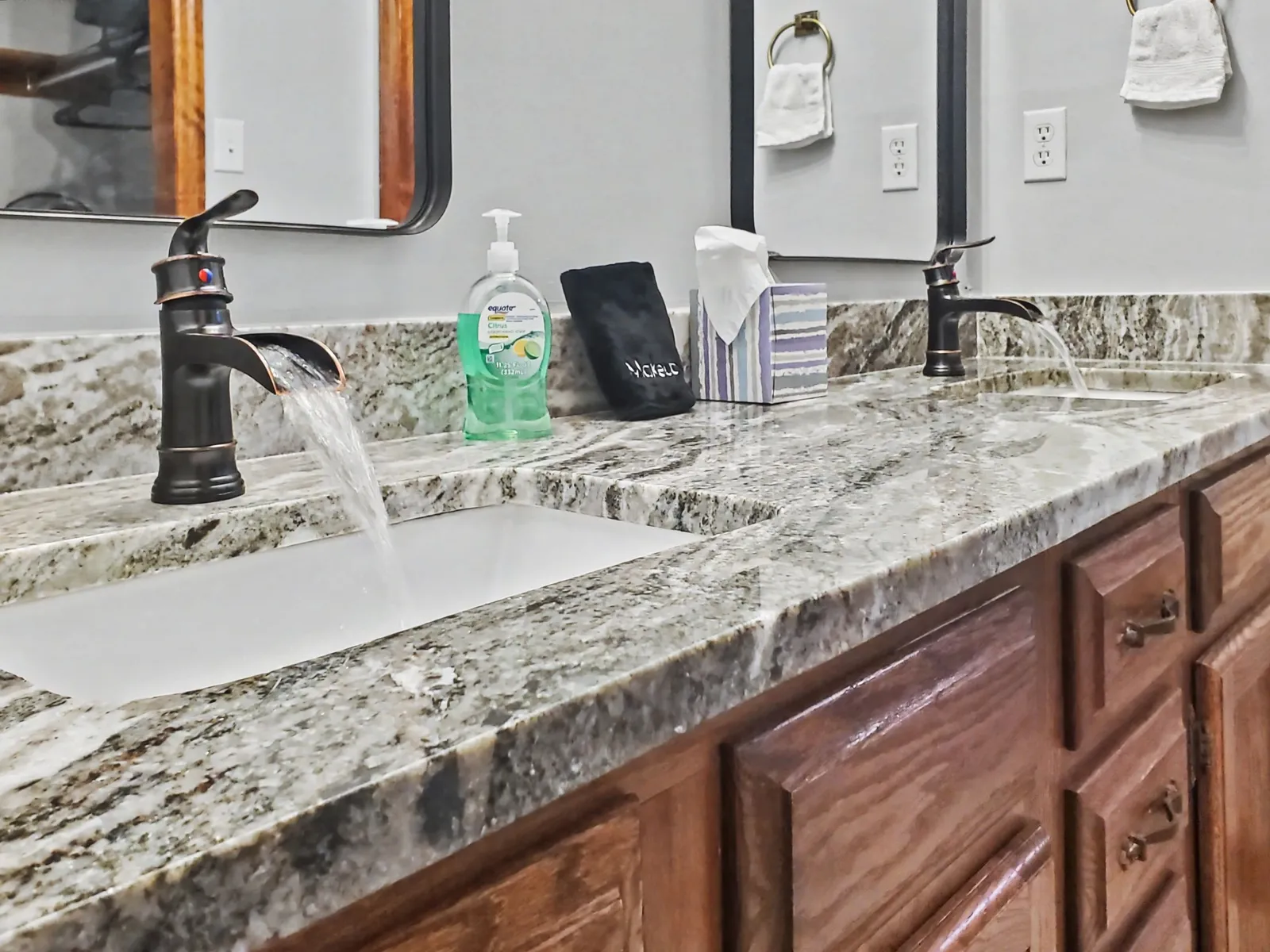 Master bathroom double vanity sink with upgraded faucets and granite countertops