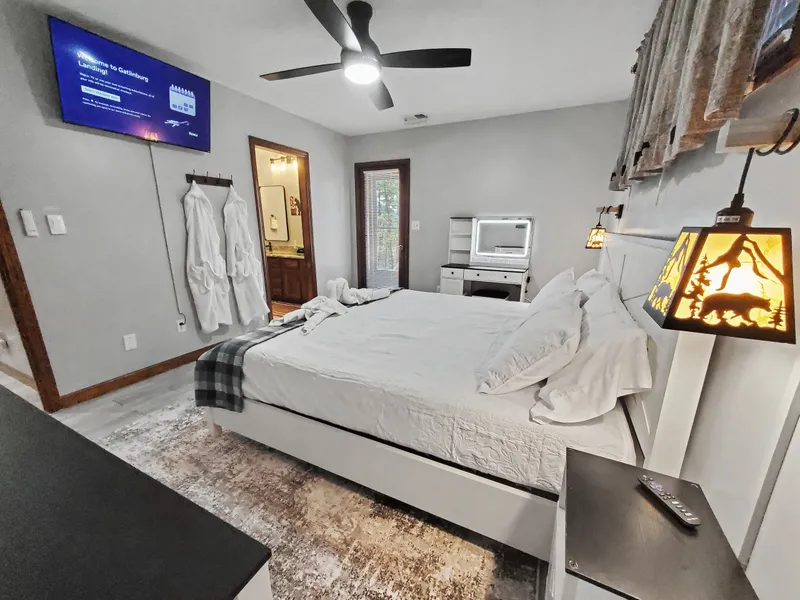 Picture of the master bedroom with 43 inch Smart TV, bath robes, and king size bed