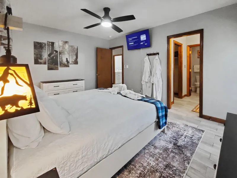 Picture of the master bedroom with 43 inch Smart TV, bath robes, and king size bed