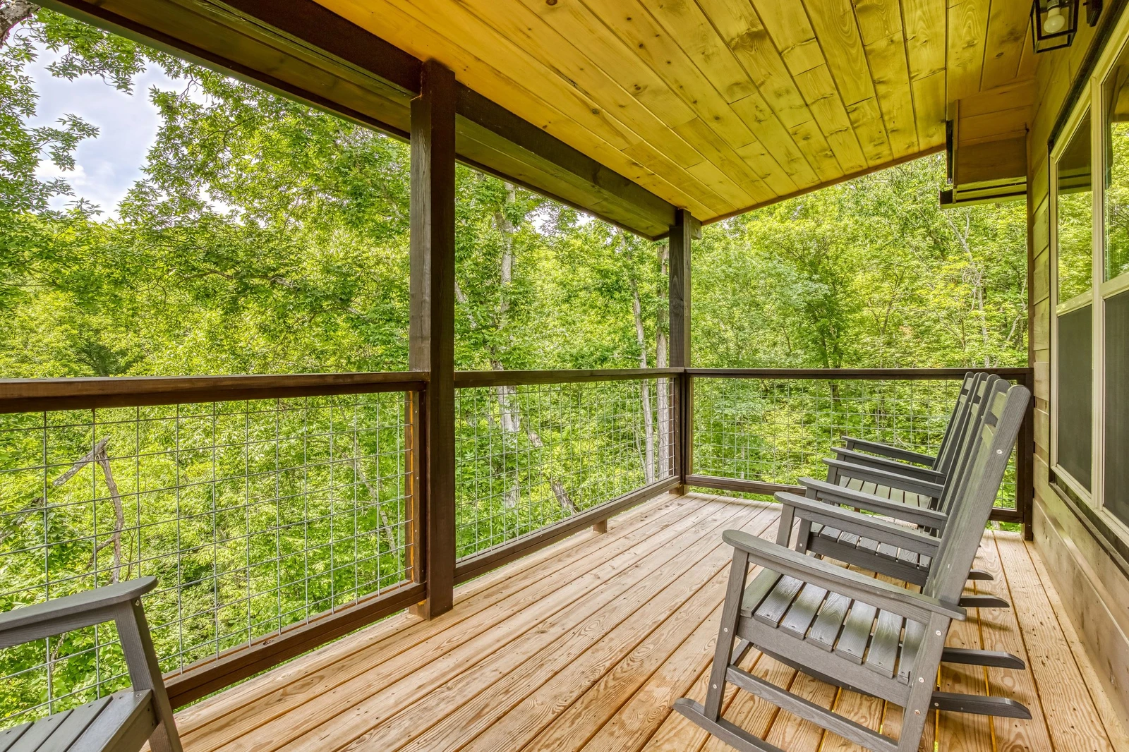 Mountain Memories main level covered back deck with rocking chairs