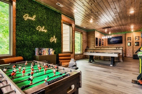 Game room with pool table, foosball table, arcades, board games, theater and half bath