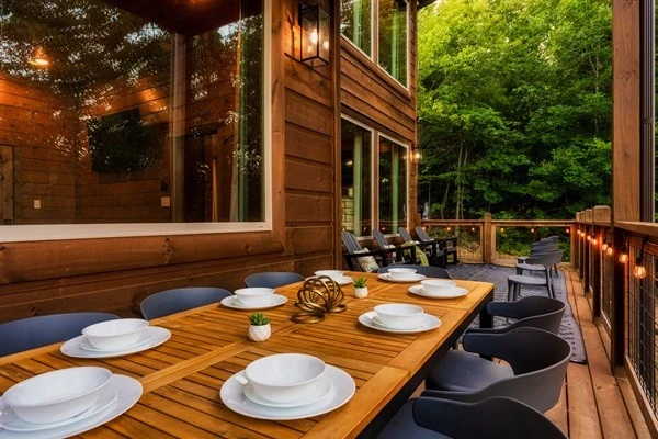 Dine on the back deck with string lights and nature views