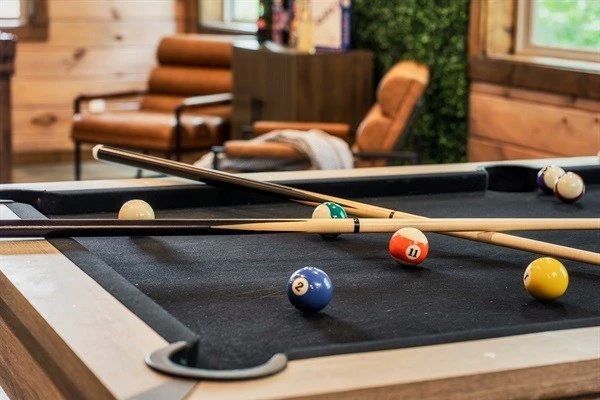 Game room with pool table, foosball table, arcades, board games, theater and half bath