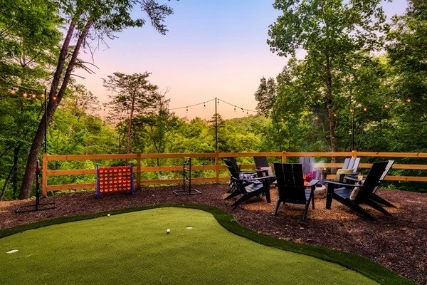 Backyard with fire pit, mini golf, string lights and games