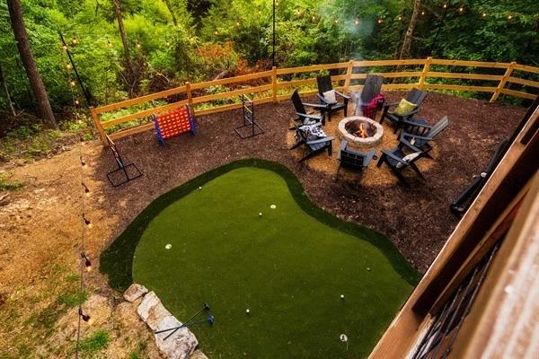 Backyard with fire pit, mini golf, string lights and games
