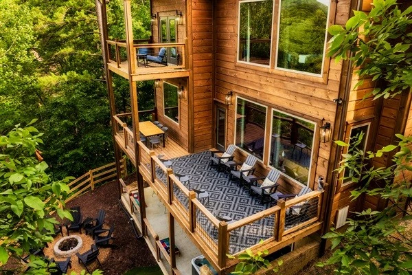 Luxury cabin with multiple decks, outdoor seating, nature views, string, lights, fire pit, mini golf and hot tub