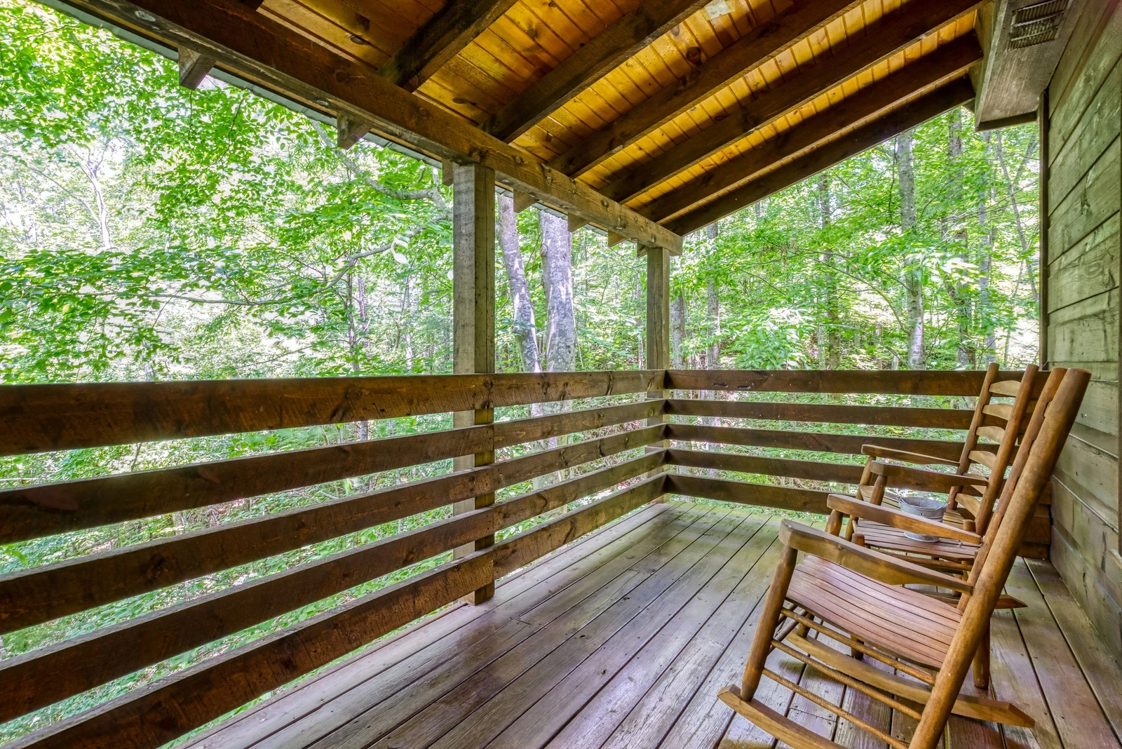 Rocking Chairs back deck next to hot tub Naughty Pines Cabin Rental