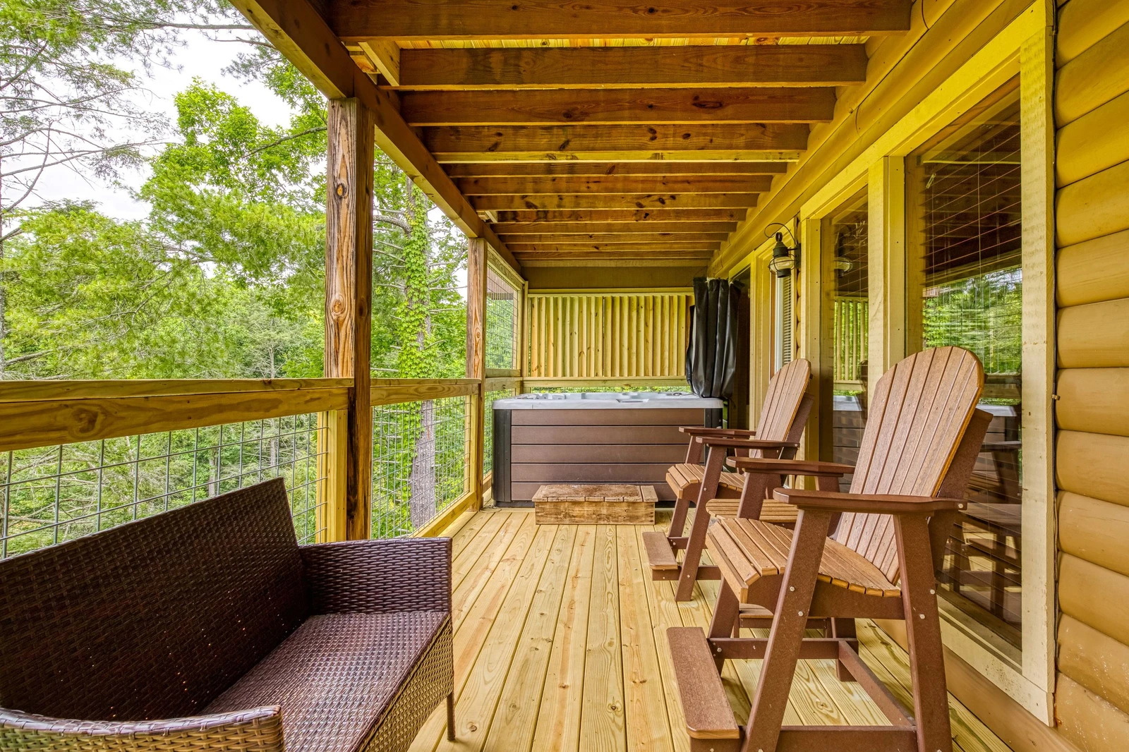Bearadise Mountain Lodge main level covered back deck with hot tub